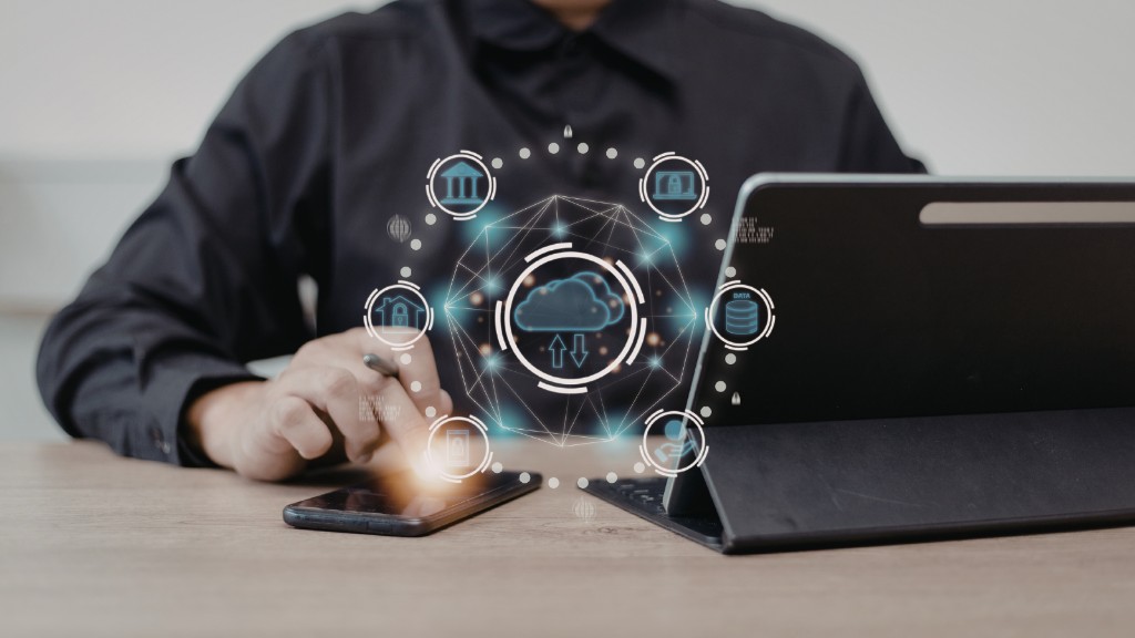 Small business owner using laptop and phone with cloud-based AI worker tools for secure operations and workflow automation.